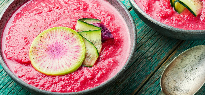 Chilled beetroot salmorejo in bowls with cucumber and radish