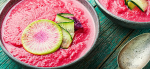 Chilled beetroot salmorejo in bowls with cucumber and radish