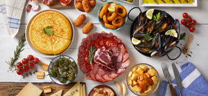 Spanish tapas spread with tortilla, seafood, cured meats, peppers and patatas bravas